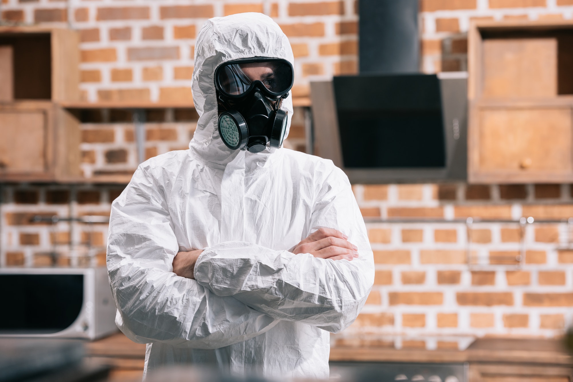 pest-control-worker-standing-in-uniform-with-crossed-arms-in-kitchen.jpg